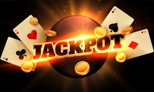 An image of the word jackpot with playing cards and gold coins on a dark background