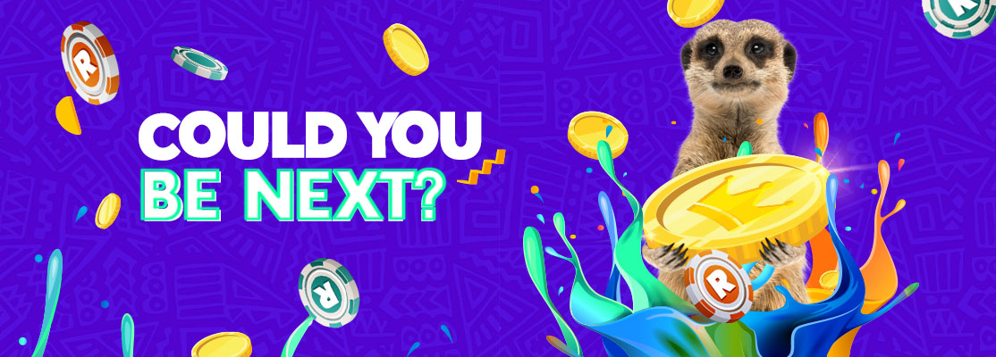 "The Biggest Wins Ever&rdquo; text beside a meerkat pulling the lever on a winner slot machine, surrounded by gold coins, casino chips and colourful graphics.