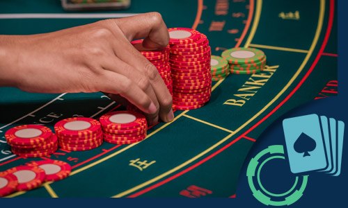 baccarat table with a hand stacking chips