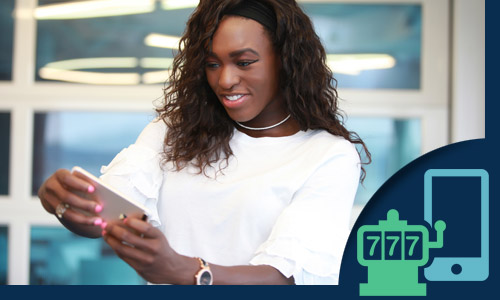 woman standing outside a land-based casino playing online casino games on her phone.