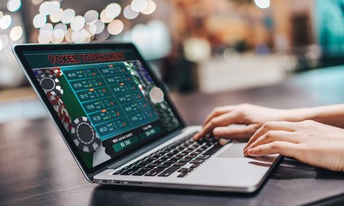 man playing casino games on a laptop  